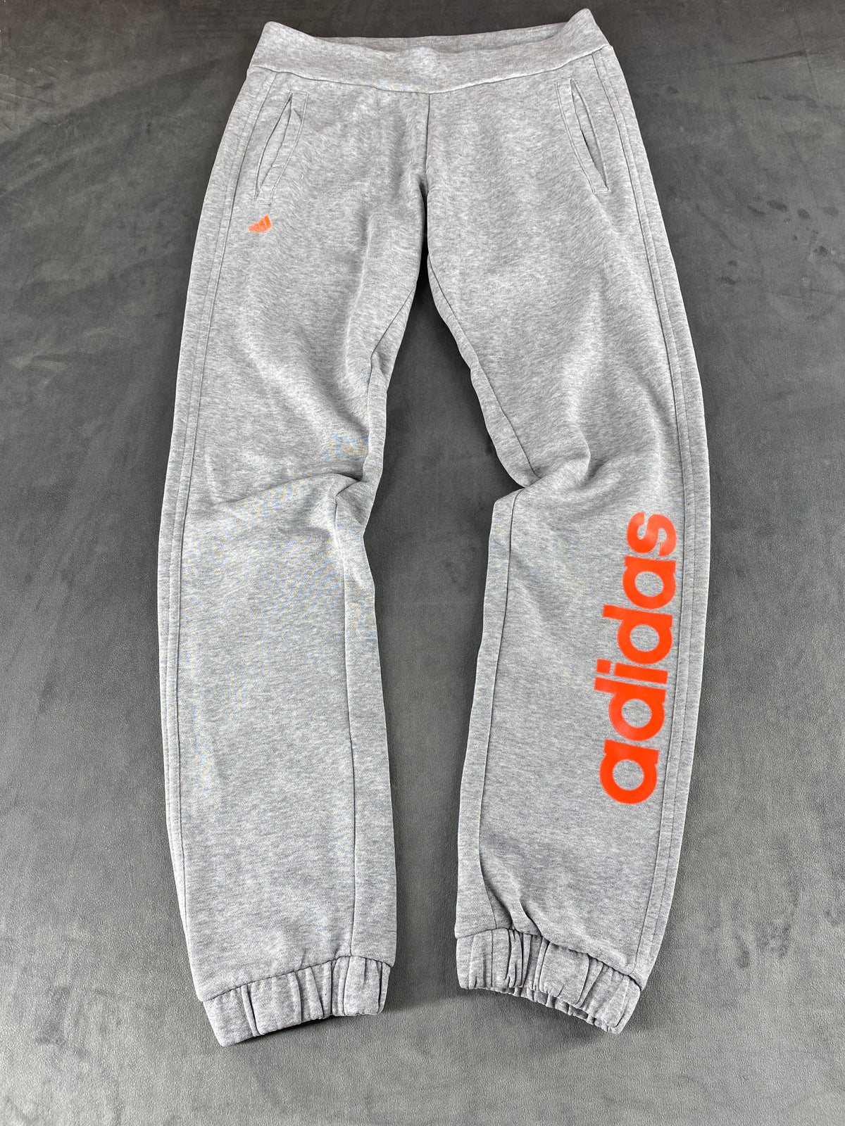 Pantaloni tuta Adidas grigi con logo arancione – Donna Taglia S