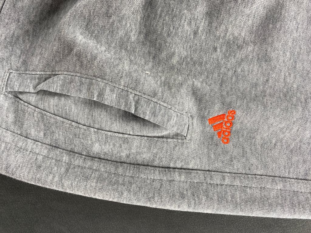 Pantaloni tuta Adidas grigi con logo arancione – Donna Taglia S