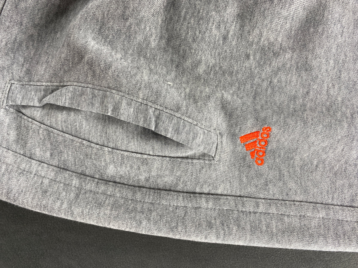 Pantaloni tuta Adidas grigi con logo arancione – Donna Taglia S